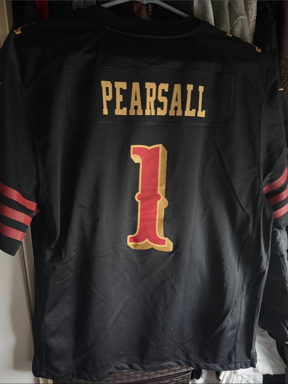 Nike YOUTH Black 'Faithful' #1 Football Jersey with Red and Gold Accents.
